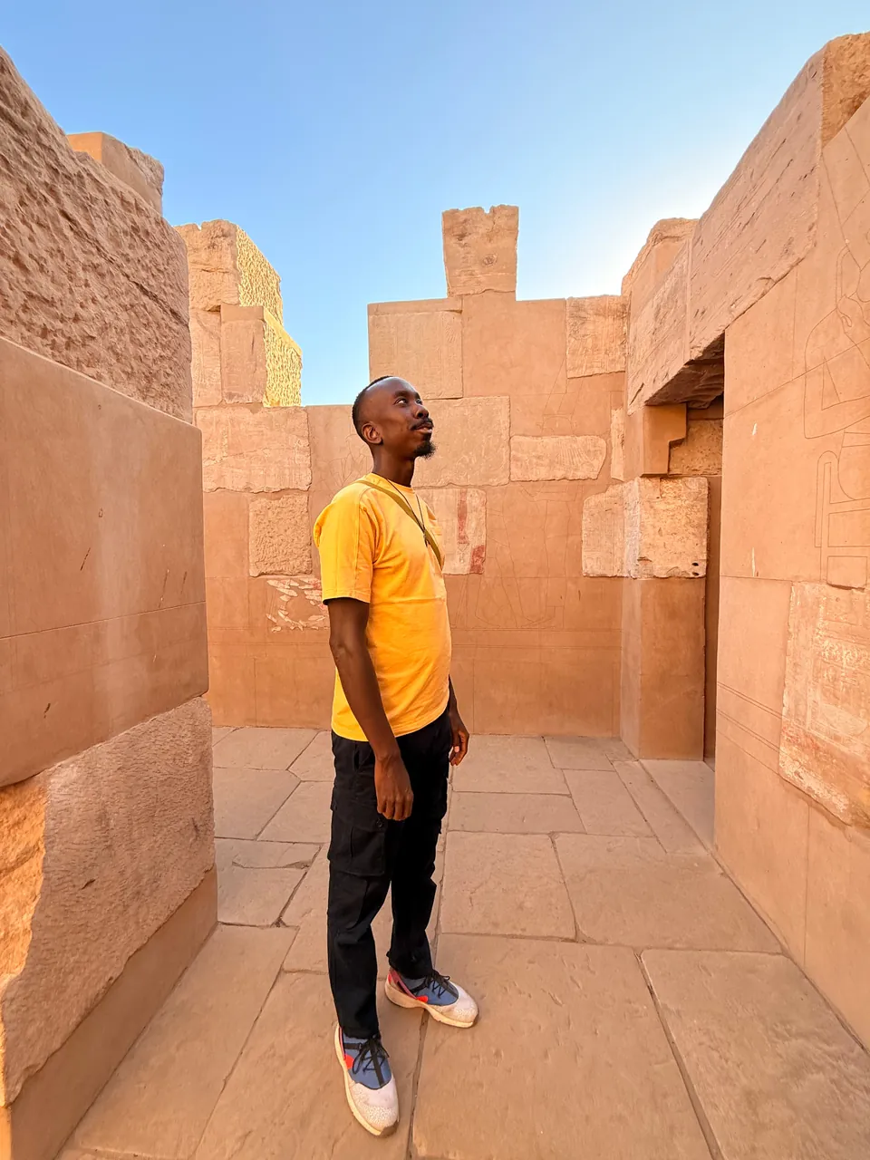 Jordan looking up at ancient Egyptian temple carvings.